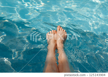 A girl's feet in a blue pool. Epilation of legs, varicose veins. Rest, relaxation on the beach, at the hotel. A woman in freedom. Vacation. High quality photo A girl's feet in a blue pool. Epilation of legs, varicose veins. Rest, relaxation on the beach, at the hotel. A woman in freedom. Vacation. High quality photo 125143904