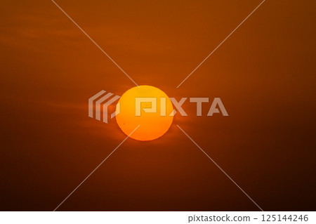 Yokohama cityscape in Japan: Sunspot...A bright red sun rises in the clear sky. A huge sunspot can be seen in the sun = 17th Yokohama cityscape in Japan: Sunspot...A bright red sun rises in the clear sky. A huge sunspot can be seen in the sun = 17th 125144246
