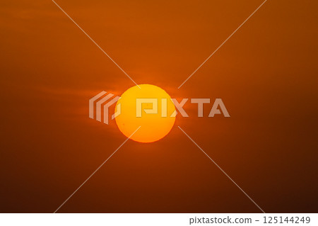 Yokohama cityscape in Japan: Sunspot...A bright red sun rises in the clear sky. A huge sunspot can be seen in the sun = 17th Yokohama cityscape in Japan: Sunspot...A bright red sun rises in the clear sky. A huge sunspot can be seen in the sun = 17th 125144249