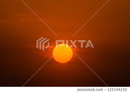 Yokohama cityscape in Japan: Sunspot...A bright red sun rises in the clear sky. A huge sunspot can be seen in the sun = 17th 125144250