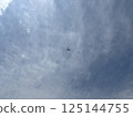 Plane in the middle of the sky with clouds 125144755