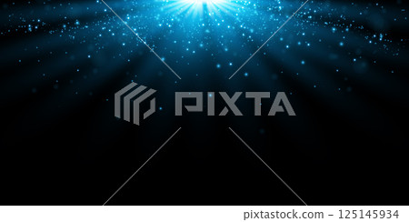 Stunning and Beautiful Blue Light Rays with Sparkles shining on a Deep Dark Background, creating a mesmerizing effect 125145934