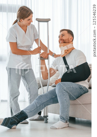 Nurse is helping injured man at home 125146239