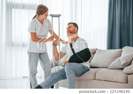 Nurse is helping injured man at home 125146240