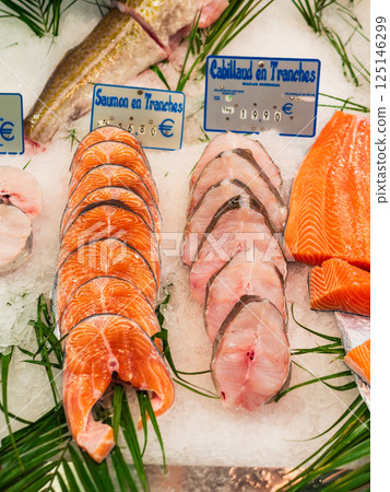 Salmon and cod fillets at a market in Paris 125146299
