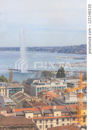 Panoramic view of city of Geneva, Lake Geneva and Jet d'Eau fountain in Switzerland. View from the bell tower of Saint Pierre Cathedral 125146530