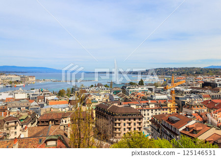 Panoramic view of city of Geneva, Lake Geneva and Jet d'Eau fountain in Switzerland. View from the bell tower of Saint Pierre Cathedral 125146531