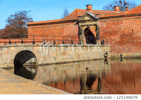 Brick stone bridge across the lake surrounding Frederiksborg castle in Hillerod, near Copenhagen, Denmark Brick stone bridge across the lake surrounding Frederiksborg castle in Hillerod, near Copenhagen, Denmark 125146676