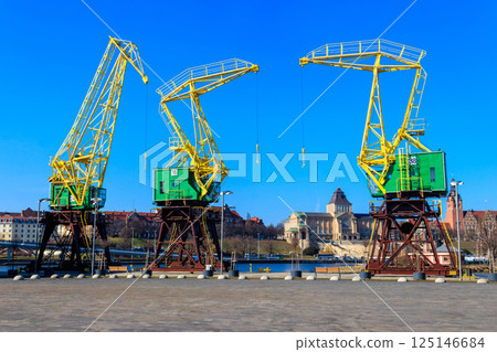 Old cranes on city boulevard in Szczecin, Poland Old cranes on city boulevard in Szczecin, Poland 125146684