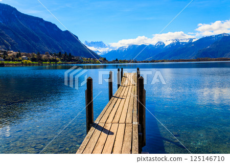 Wooden pier overlooking the Alps and Lake Geneva in Switzerland Wooden pier overlooking the Alps and Lake Geneva in Switzerland 125146710