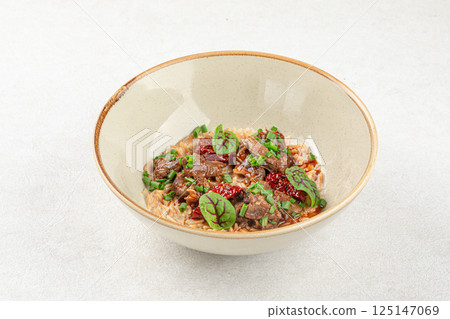 Portion of pasta orzo with meat and basil Portion of pasta orzo with meat and basil 125147069