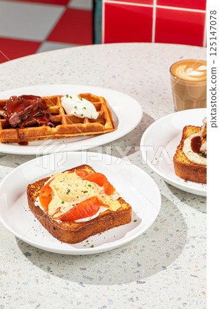 Served table with brunch toasts and waffle Served table with brunch toasts and waffle 125147078