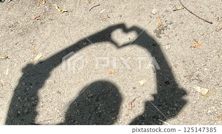 Heart-shaped shadow made by hands_wide 125147385