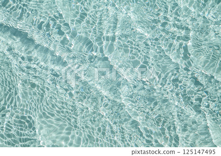 Blue transparent water with flecks of sunshine 125147495