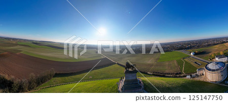 An Expansive Panoramic View of Serene Green Fields Stretching Under a Clear Blue Sky An Expansive Panoramic View of Serene Green Fields Stretching Under a Clear Blue Sky 125147750