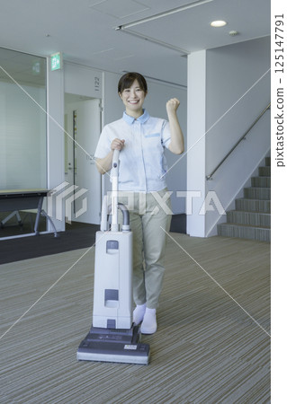 Portrait of a female cleaner vacuuming in an office building. Photo courtesy of Tokyo Electronics College, Denpa Gakuen School Corporation. Portrait of a female cleaner vacuuming in an office building. Photo courtesy of Tokyo Electronics College, Denpa Gakuen School Corporation. 125147791