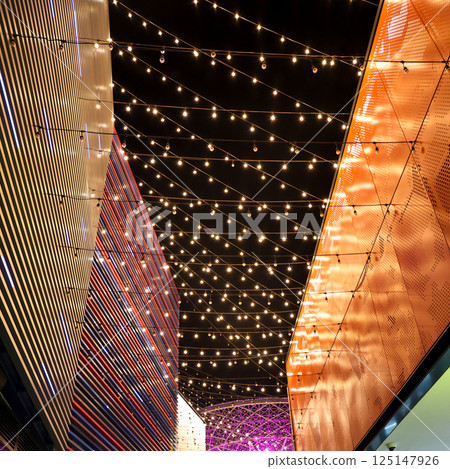 The night sky is decorated with lanterns suspended on ropes between houses 125147926