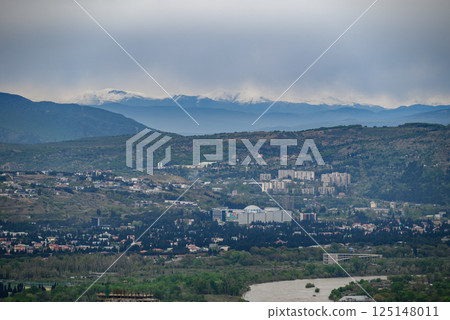 Cityscape view of Tbilisi, the capital of Georgia with snow-capped Caucasus mountains in the distance 125148011