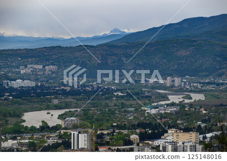 Cityscape view of Tbilisi, the capital of Georgia with snow-capped Caucasus mountains in the distance 125148016