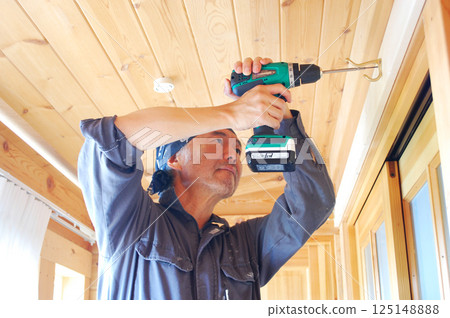 DIY Man drilling holes with an electric drill, part 2 125148888