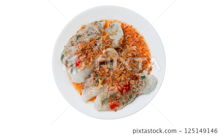 A vibrant plate of Vietnamese rice rolls filled with savory minced meat and vegetables, topped generously with crispy fried shallots and spicy chili sauce, served on a clean white plate A vibrant plate of Vietnamese rice rolls filled with savory minced meat and vegetables, topped generously with crispy fried shallots and spicy chili sauce, served on a clean white plate 125149146