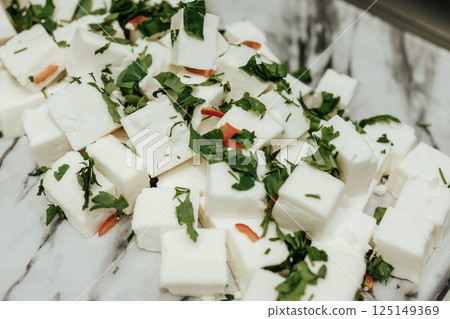 Brine goat cheese. Delicate curd cheese with spices and herbs. 125149369