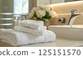 Freshly Laundered Towels and Perfectly Arranged Toiletries in a Serene and Inviting Bathroom Setting 125151570