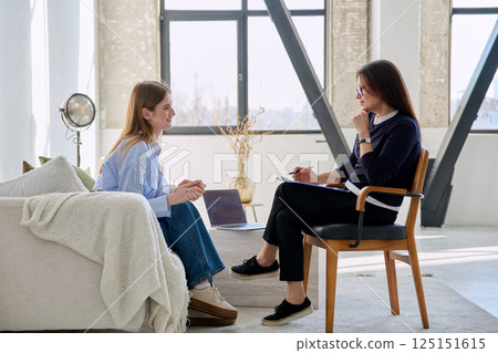 Young woman patient during therapy session in professional mental therapist's office Young woman patient during therapy session in professional mental therapist's office 125151615