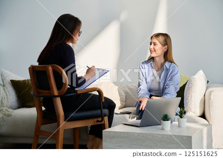 Young woman patient in mental session talking with professional psychologist Young woman patient in mental session talking with professional psychologist 125151625