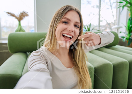 Beautiful happy smiling young woman healthy natural teeth on camera, selfie view 125151656