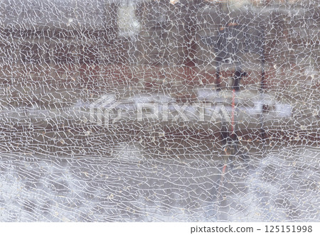 Texture of cracked broken glass cracked by impact. Texture of cracked broken glass cracked by impact. 125151998