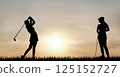 Women playing golf at sunset 125152727