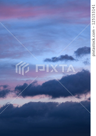 Vertical photograph of blue clouds in overcast weather at sunset. Aesthetic neutral photo. Romantic sky. Vertical photograph of blue clouds in overcast weather at sunset. Aesthetic neutral photo. Romantic sky. 125153141