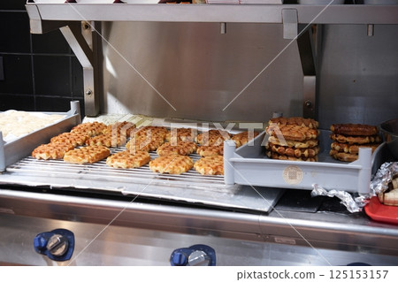 Freshly Baked Belgian Waffles Cooling in Bakery Display 125153157