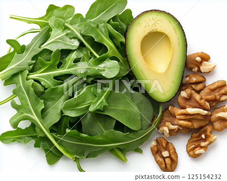 Fresh arugula leaves with half avocado and crunchy walnut kernels 125154232