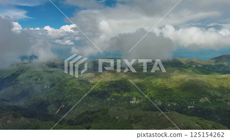 Clouds over summer green mountains Clouds over summer green mountains 125154262
