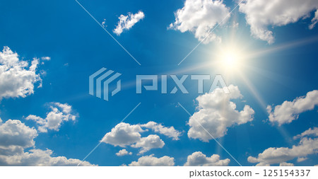 Bright sun on beautiful blue sky with white clouds. 125154337