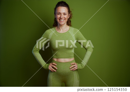 Smiling woman in green activewear Smiling woman in green activewear 125154350