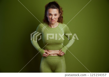 Frustrated woman pinching her stomach fat 125154357