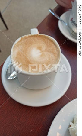 A cup of cappuccino with foam art A cup of cappuccino with foam art 125154556
