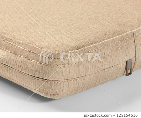 Beige fabric cushion cover corner showing zipper and stitching Beige fabric cushion cover corner showing zipper and stitching 125154616