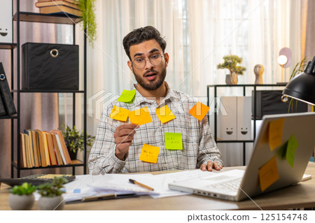 Indian businessman work on laptop sticky notes with many tasks inscription overworked at office 125154748