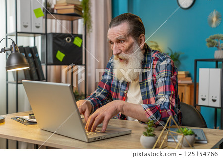 Frustrated senior man having software problems with laptop, angry man get nervous seeing error virus 125154766