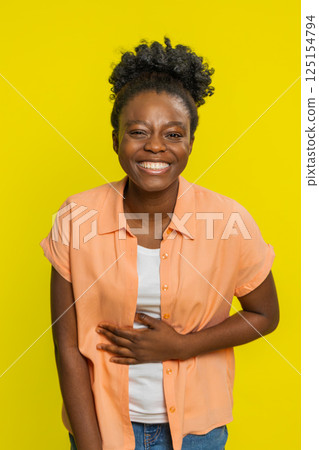 Amused smiling cheerful Black woman laughing out loud funny ridiculous joke anecdote bullying abuse 125154794