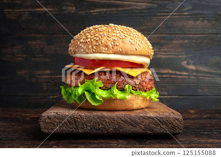Chicken burger, cheeseburger on dark wooden background 125155088
