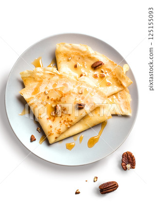 Crepes with honey and pecan nuts isolated 125155093