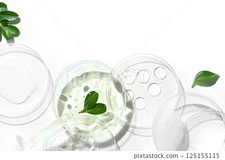 Petri dishes with green plants, pipette and cosmetic swatches Petri dishes with green plants, pipette and cosmetic swatches 125155115