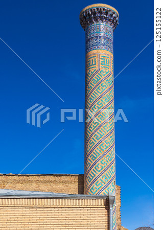 Minaret of Gur-e-Amir is under blue sky, it is a mausoleum complex Minaret of Gur-e-Amir is under blue sky, it is a mausoleum complex 125155122