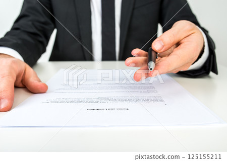 Businessman offering you to sign a document with focus to the text Terms and Conditions 125155211