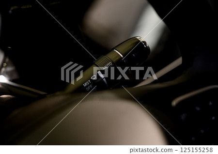 Close up view of car light switch control. Headlight switch, turn signal lever Close up view of car light switch control. Headlight switch, turn signal lever 125155258
